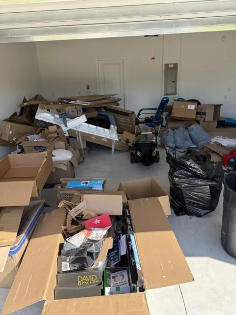Residential garage cleanout — boxes and clutter cleared by Jax Junk Solutions in Jacksonville, FL